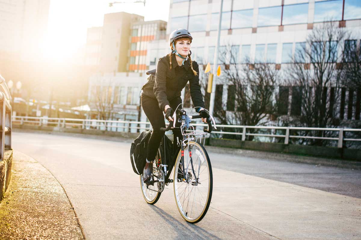 A woman riding a bike in the city.